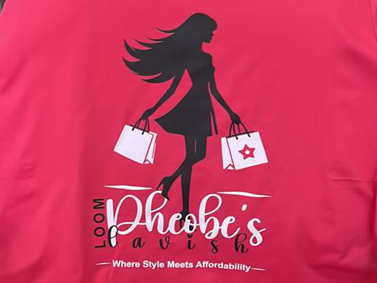 A pink t-shirt screen printed with the Phoebe's Lavish Loom logo and the line Where Style Meets Affordability